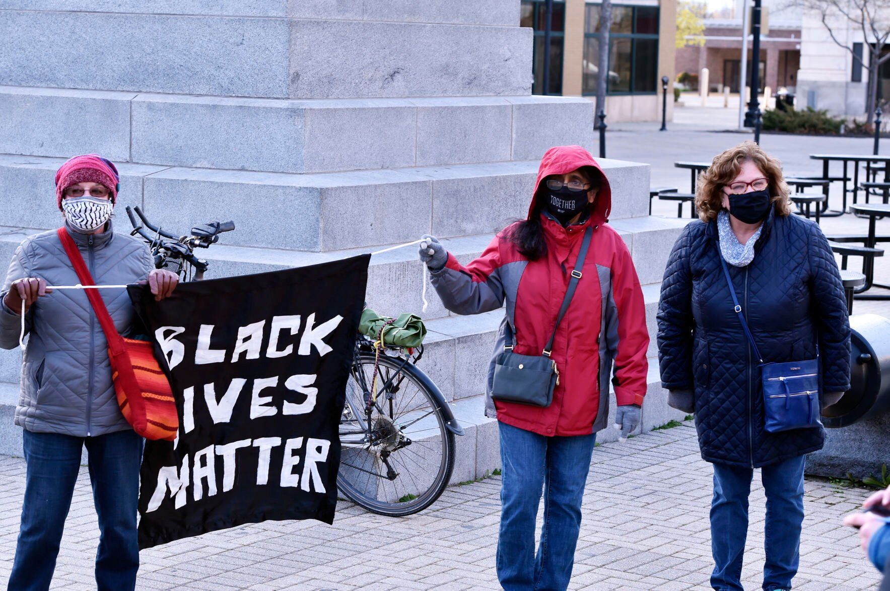 Carrying a Black Lives Matter flag on Monument Square after Derek Chauvin is convicted in the killing of George Floyd